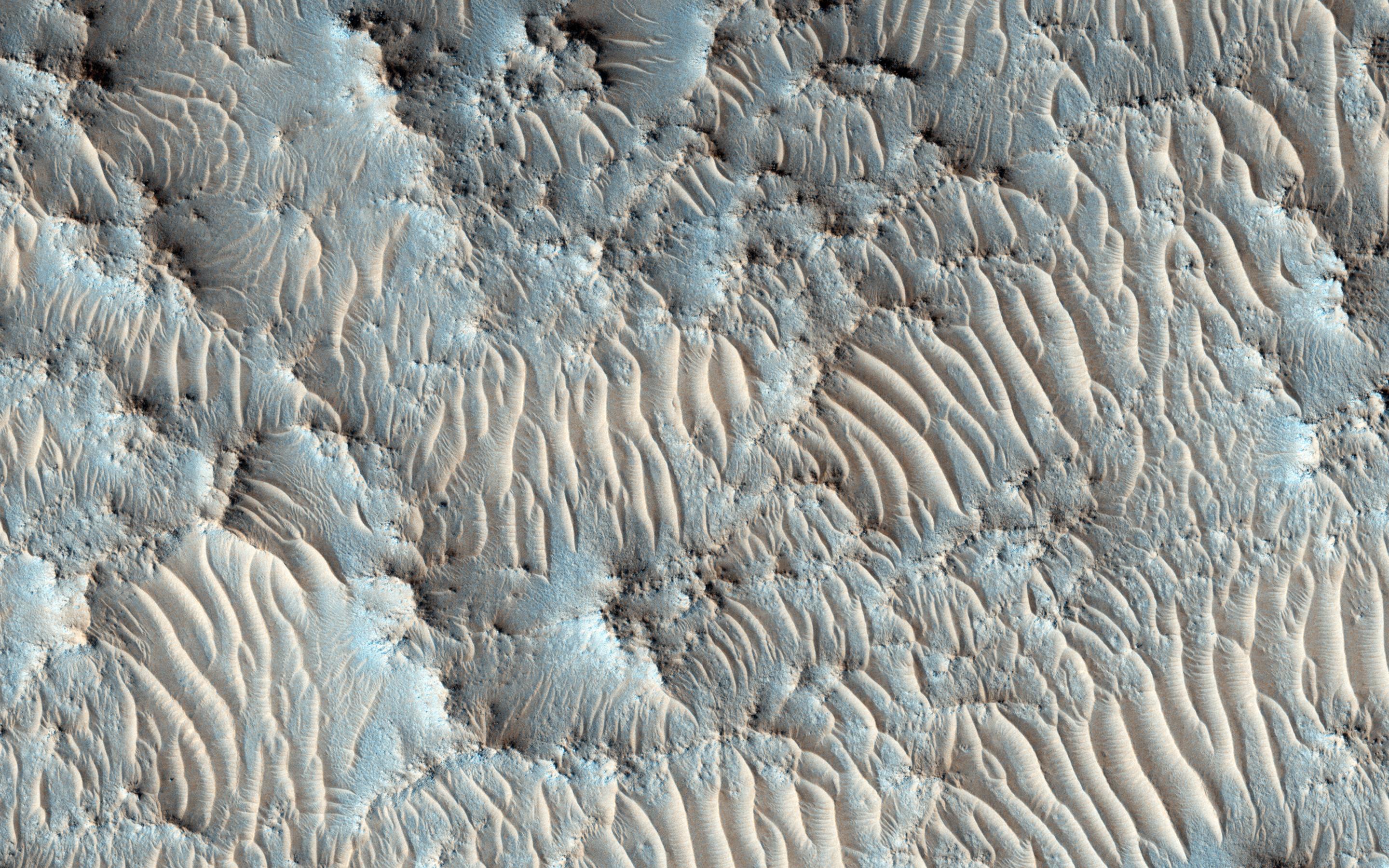 Jezero crater on Mars from orbit, the ancient river delta still standing in rock.