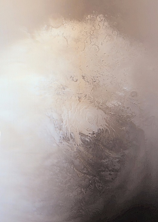 Mars Global Surveyor wide-angle view of the south polar region in spring, 12 September 2001. Bright permanent cap at centre, seasonal frost around it, afternoon clouds to the left.