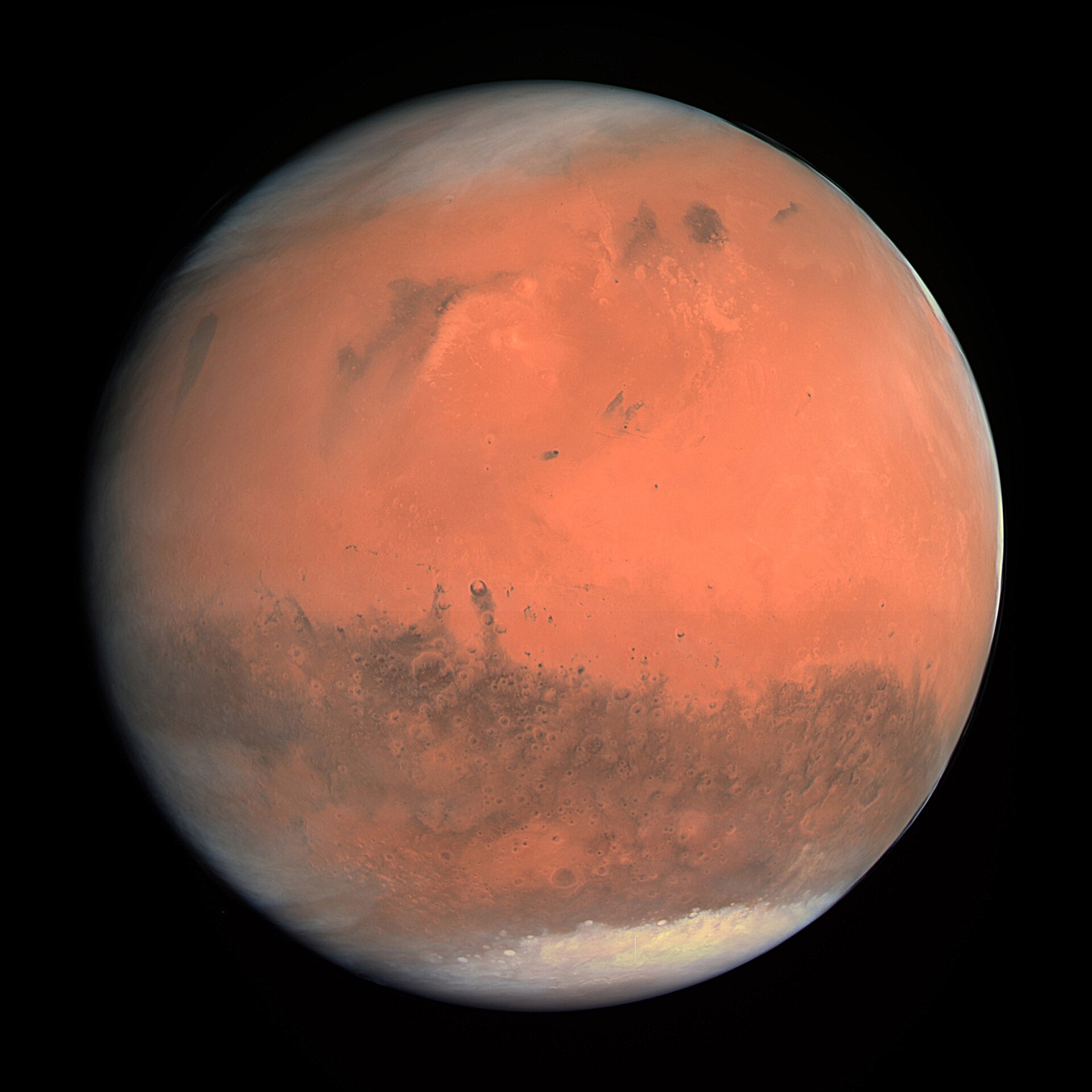 True-colour disc of planet Mars from Mars Express OSIRIS: rust continents, white polar ice, thin dusty limb.